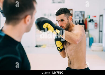 Man wearing boxing gloves sparring Stock Photo