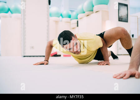 Man doing push ups Stock Photo