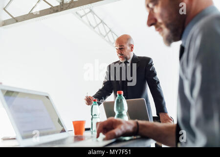 Businessman talking with colleagues Stock Photo