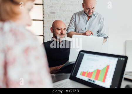 Colleagues using laptops Stock Photo