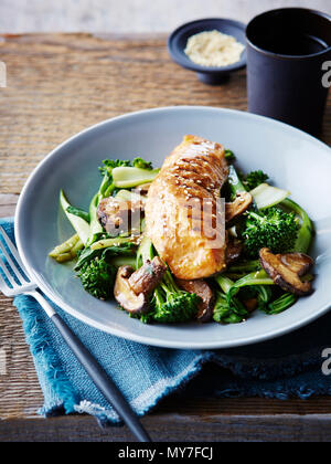 Miso and maple glazed salmon on stir fried asian greens, close-up Stock Photo