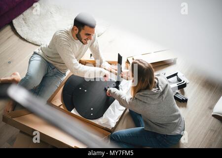 Couple assembling flat pack furniture Stock Photo