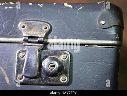 Old shabby suitcase on a wooden floor Stock Photo