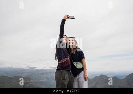 Two young female tourists taking selfie from The Three Rondavels, Mpumalanga, South Africa Stock Photo