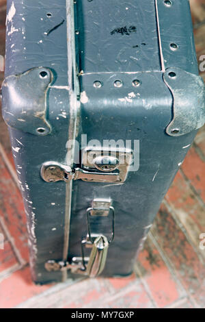 Old shabby suitcase on a wooden floor Stock Photo