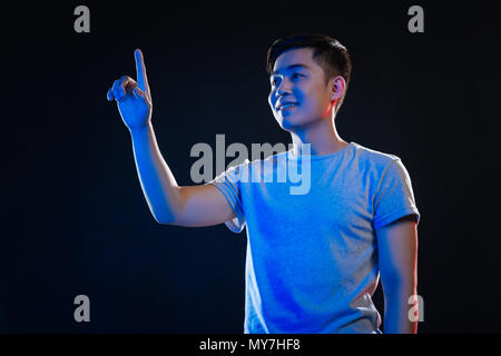Positive happy man touching the sensory screen Stock Photo