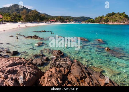 Beautiful scenic view of the rocky part of Long Beach (Pasir Panjang) on Redang Island in Terengganu, Malaysia. Tourists enjoying their leisure time. Stock Photo