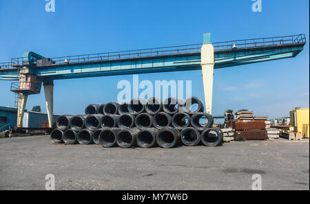 Stacked cable bundles lay near bridge crane in Burgas port, Bulgaria Stock Photo