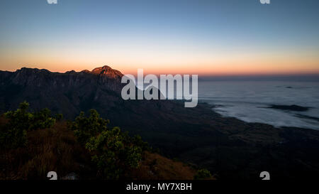 Chambe glowing in the first light of the day with a sea of clouds in the valley below.. Stock Photo