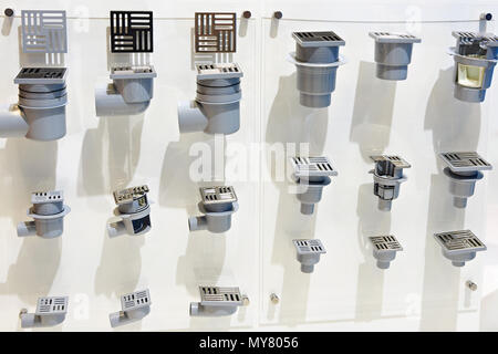 Plums with grating for sewer pipes for shower in store Stock Photo