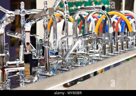 Modern kitchen water faucets in the store Stock Photo