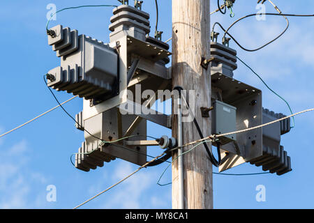 some electrical equipment high up on a pole one Stock Photo