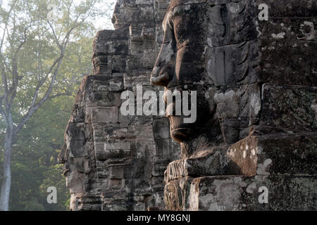 Siem Reap Cambodia,  Anthropomorphic  faces carved into stone at the  Bayon Wat, a 12th century temple within the Angkor Thom complex Stock Photo
