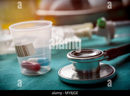 Stethoscope along with doses of medicine in a hospital, conceptual image Stock Photo