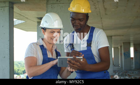 Construction people using electronic tablet on site Stock Photo