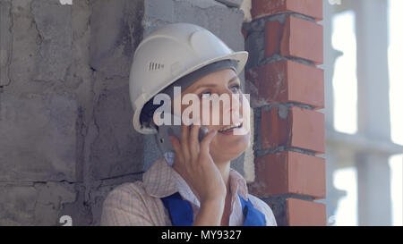 Confident female architect talking on phone Stock Photo