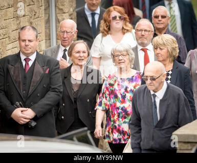 Widow Pat Wilson (2nd right in colourful top) and Sir Bobby Charlton (2nd left) with his wife Norma Ball (3rd left) following the funeral of 1966 World Cup hero Ray Wilson at Huddersfield Crematorium. Stock Photo
