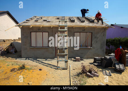 Soweto, South Africa, September 10, 2011,  Diverse Community members building a low cost house as a team in Soweto Stock Photo