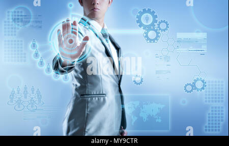 Business man in blue grey suit using hand pressing on digital virtual screen, business concept of marketing strategy plan Stock Photo