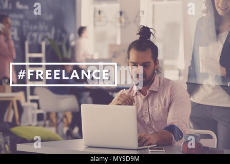 Young and creative freelance worker using laptop at work Stock Photo