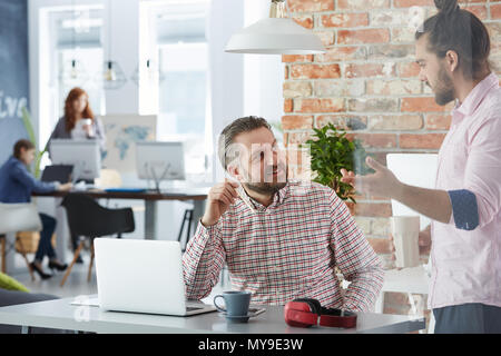 Creative man working in industrial style office Stock Photo