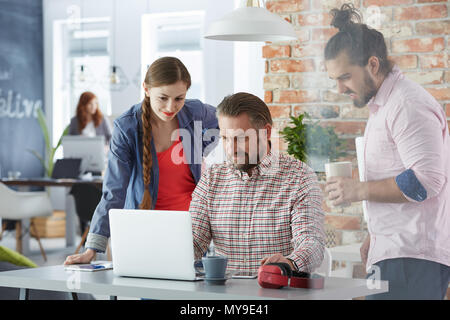 Creative business team working together with laptop Stock Photo