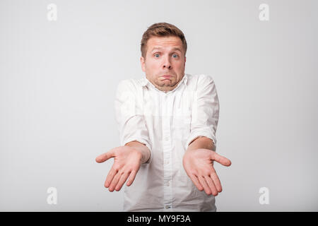 Portrait of handsome caucasian guy being surprised and clueless, being insecure and not sure about answer Stock Photo