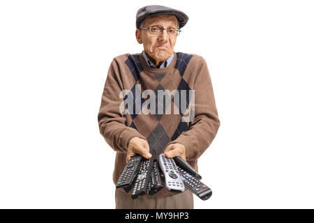 Confused elderly man holding a bunch of remotes isolated on white background Stock Photo