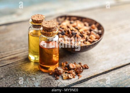 A bottle of myrrh essential oil with myrrh resin on a dark background Stock  Photo - Alamy