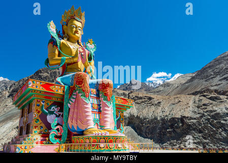 Buddha statue on the background of sky and rocky Himalayas in Nubra Valley Ladakh. India July 2015 Stock Photo