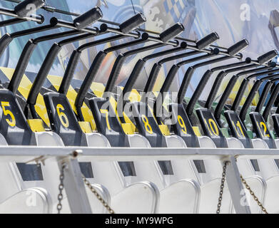 Seats numbered in order on a fairground ride with numbers starting at five, germany Stock Photo