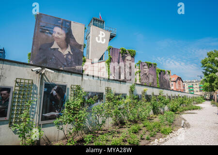 Warsaw Rising Museum, view of the museum rose garden overlooked by large portraits of resistance fighters of the uprising of 1944, Poland. Stock Photo
