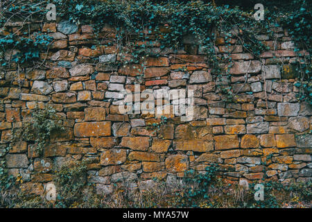Texture of a wall in the mountain made with earth-colored stones Stock Photo