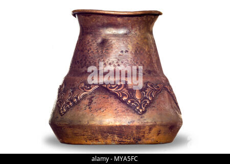An old coffee maker made in the Middle East. Copper cup and wooden handle. Turkish coffee . Isolated photo on a white background. Stock Photo