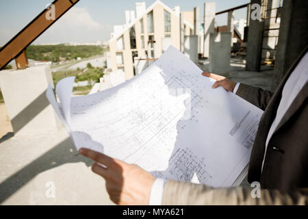 Holding house plan drawings on the structure Stock Photo