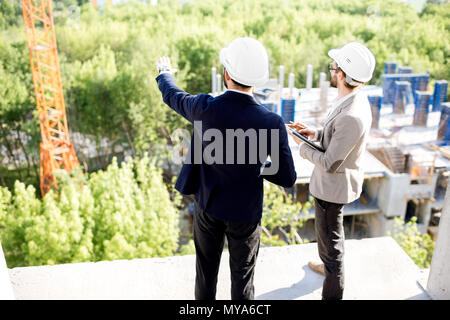 Supervising the process of house construction Stock Photo