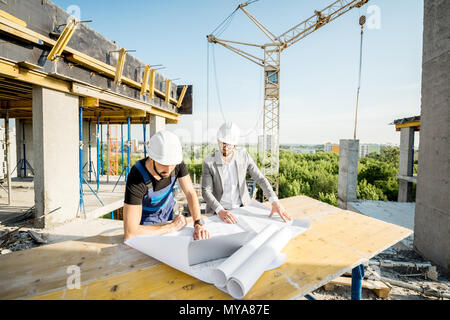 Engineer with worker at the construction site Stock Photo