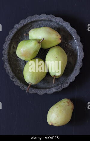 Pears in a plate on a black background Stock Photo