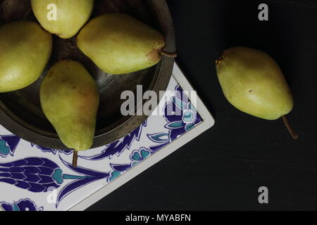 Pears in a plate on a black background Stock Photo