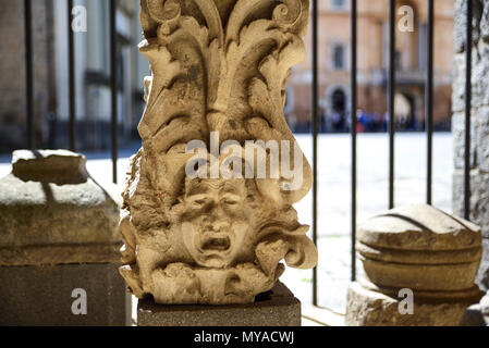 Archaeological find. Upper part (Capitello) of an ancient Etruscan column depicting a face. Orvieto, Italy Stock Photo