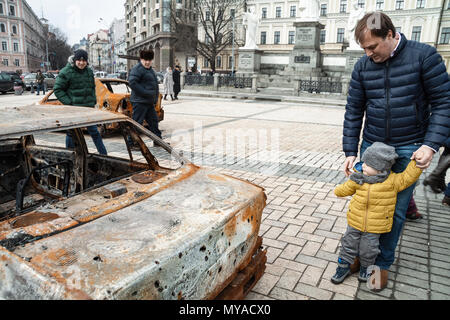 KYIV, UKRAINE - FEBRUARY 25 of 2015. People visiting the documentary exhibition Presence. Evidence of the Russian Military Aggression on the territory Stock Photo