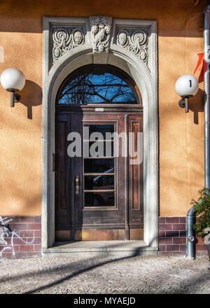Berlin Rüdesheimer Platz.Grand historic old houses around the square with gables & decorative facades. House entrance, Arched ornate  wooden door Stock Photo