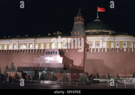 A nighttime view in Red Square showing the Lenin Mausoleum.  Behind the mausoleum is the Kremlin Wall and beyond that is the building of the Council of Ministers of the USR (formerly the Senate).  This is the seat of the Soviet government. Stock Photo