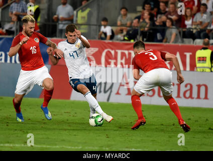 Innsbruck, Austria - May 30, 2018. Russian midfielder Roman Zobnin against Austrian players Aleksandar Dragovic and Peter Zulj during international fr Stock Photo