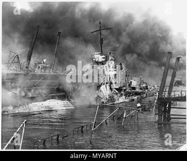 Naval photograph documenting the Japanese attack on Pearl Harbor, Hawaii -  Navy's caption The twisted remains of the destroyer USS Shaw burning in floating drydock 12 7 1941 Stock Photo