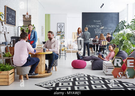 People working in modern agency relaxing during lunch break Stock Photo