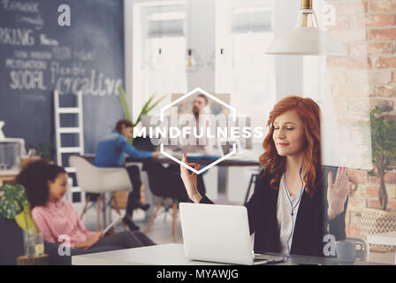 Young woman working in agency, relaxing during work, mindfulness Stock Photo
