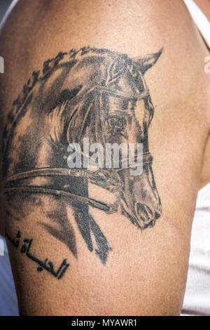 Traditional black horse tattoo on the arm - Tattoogrid.net
