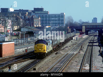 A class 37 diesel locomotive number 37888 'Petrolea' heads west with a train of bogie oil tanks at West Ealing on the 13th March 1991. Stock Photo