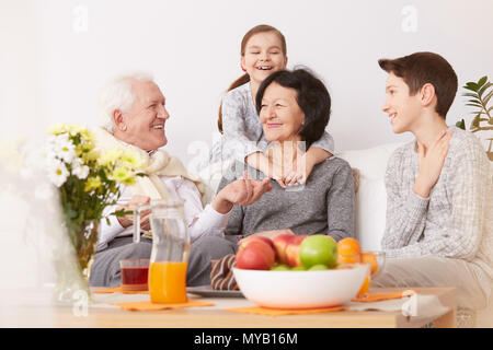 Happy family spending free time together in a living room Stock Photo